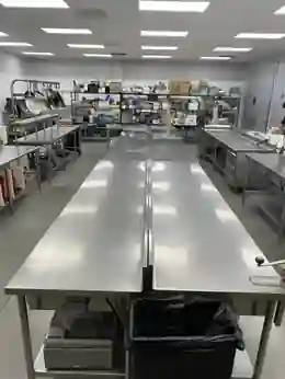 Stainless steel prep tables inside the Five Star Food Stop commissary kitchen